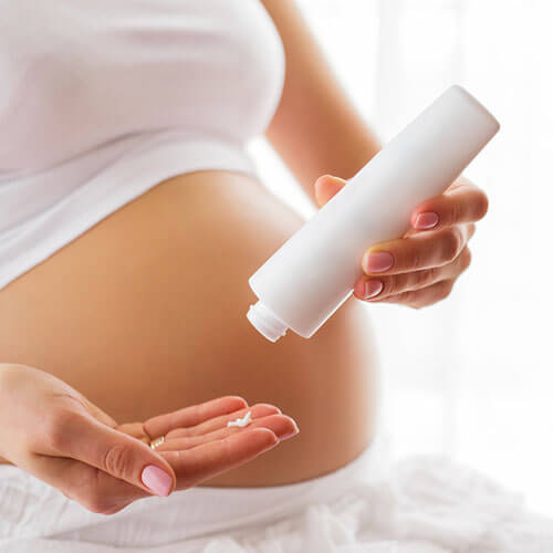 take a generous amount of stretch mark cream in your palms.