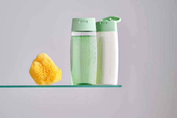 shampoo and hair conditioner on a glass shelf in the bathroom.