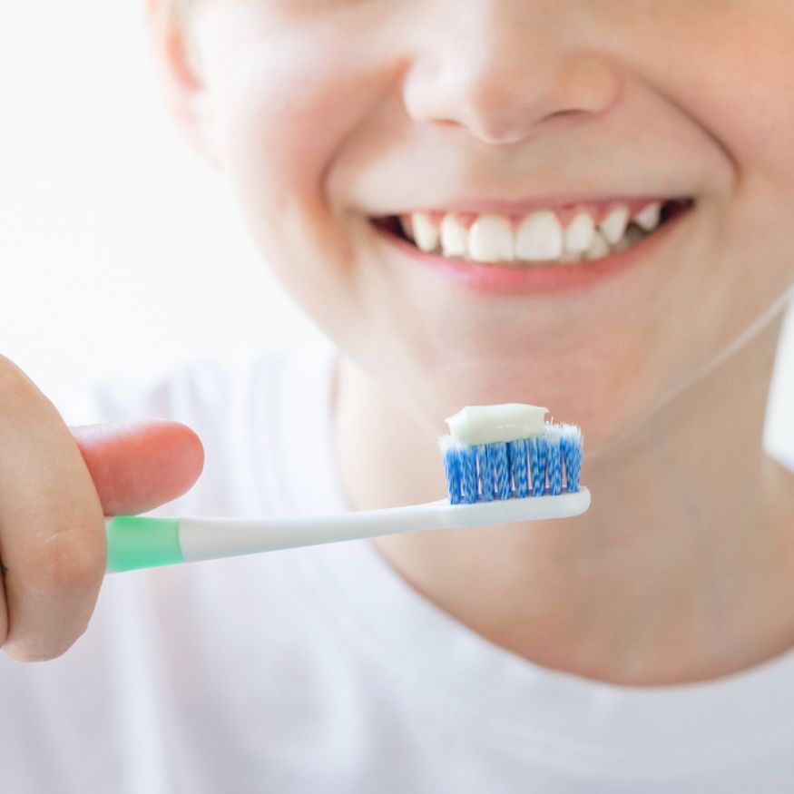 ask them to brush their teeth nicely with a soft bristled toothbrush